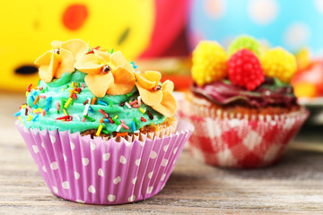 Delicious birthday cupcakes on table close-up