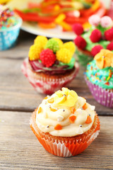 Delicious birthday cupcakes on table close-up