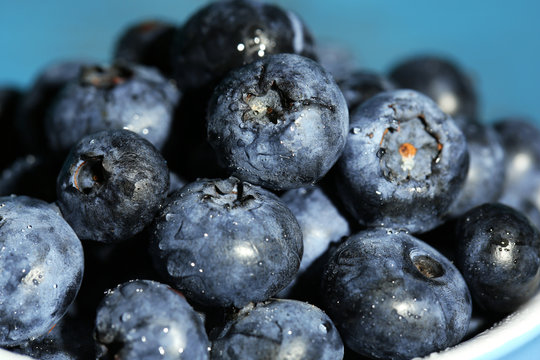 Tasty ripe blueberries, on wooden background