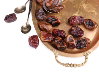 Tasty dates fruits on old metal tray, isolated on white