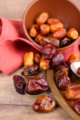 Tasty dates fruits on wooden background