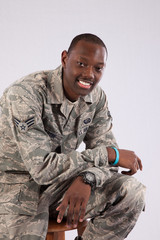 Military man sitting and smiling at the camera
