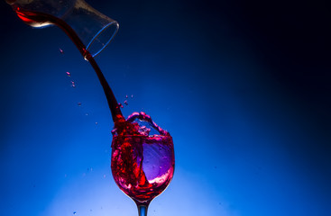 splash glass red wine blue background © Pétur Ásgeirsson