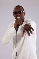 black man singing into a micdrophone