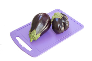 Eggplant on a plastic cutting board, white background