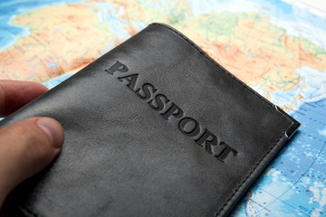 passport in the bag on a map