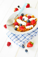 Corn flakes with yogurt and berries on plate