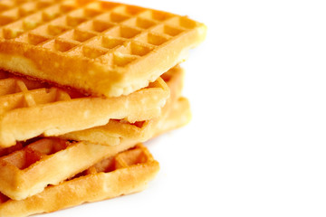 Golden waffles on white background vertical close up view