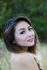Naklejka premium Asian American Woman Outdoors Portrait Bare Shoulders