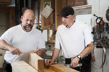 Two Carpenters with Wooden Beams