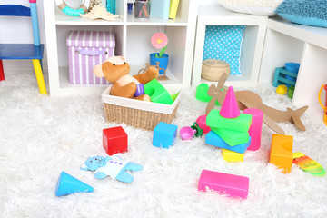 Colorful toys on fluffy carpet in children room