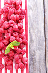 Ripe sweet raspberries on table close-up
