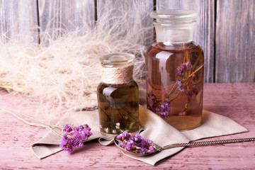 Bottles of herbal tincture and brunch of flowers