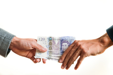 Businessmen exchanging british money pounds sterling