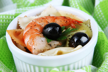 Fresh prawns with coloured macaroni and olives in a round bowl
