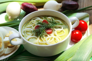 Leek soup on table, close up