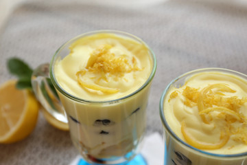 Tasty lemon desserts on table at home