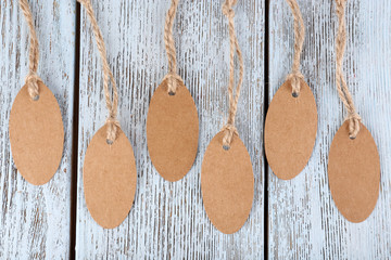 Brown tags on wooden background