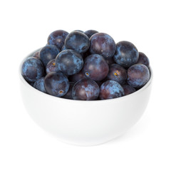 Fresh plums in bowl