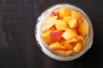 Healthy breakfast - yogurt with  fresh peach and muesli served