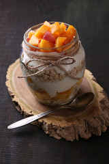 Healthy breakfast - yogurt with  fresh peach and muesli served