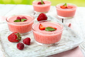 Delicious berry mousse in bowls on table close-up