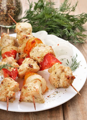 Chicken shish kebab on wooden table