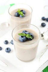 Delicious berry mousse in glasses on table close-up