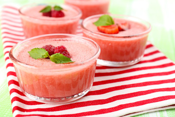 Delicious berry mousse in bowls on table close-up
