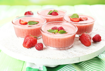 Delicious berry mousse in bowls on table close-up