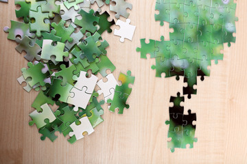 Puzzles with beautiful landscape on wooden background