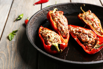 Delicious stuffed peppers in frying pan on table close-up