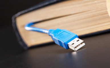 Usb cable sticks out from the book