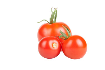 three red tomatoes of different sizes isolated on white backgrou
