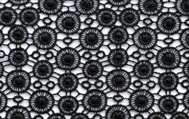 Black flowers and leaves lace material texture macro shot