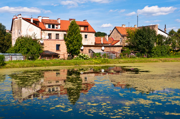 Fototapeta na wymiar Old Lithuanian Houses in Front of the Lake in Vilnius