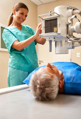Smiling and reassuring beautiful female doctor scanning male pat