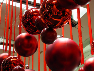 Red Ornaments and Ribbons Hanging From Ceiling