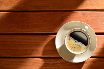 A cup of coffee on wooden table