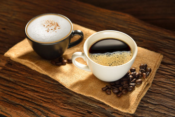 Cup of coffee and coffee beans on burlap sack