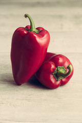 Sweet red peppers, on a wooden background