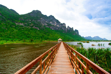 Naklejka premium Wooden Bridge in lake under blue sky , Samroiyod national park,