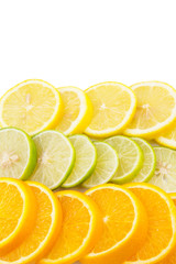 Fototapeta premium Lime, lemon and orange layer slices over white background