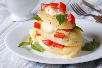 potatoes with mozzarella, tomato and basil closeup horizontal