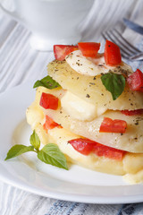 potatoes with mozzarella, tomato and basil closeup vertical