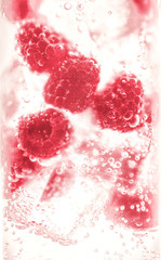 Cocktail drink with raspberries and ice