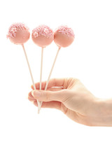 Pink and yellow cake pops isolated on white background