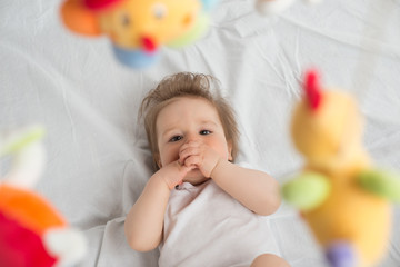 Naklejka premium Baby boy with finger in the mouth