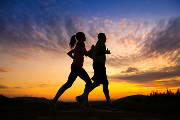 Silhouette of couple running