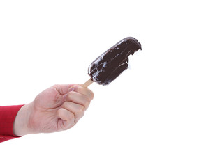 Hand holds chocolate ice cream.